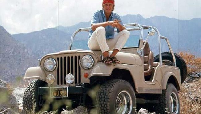 Steve McQueen with his Jeep CJ5 special V8 taking a break from training for the Baja 1000 offroad race, 1969.